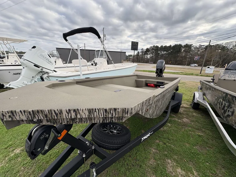 Slide: The Image of 2025 Thor Lake Hammer Hybrid 1754 boat on display, featuring a camouflage design and trailer. - 2