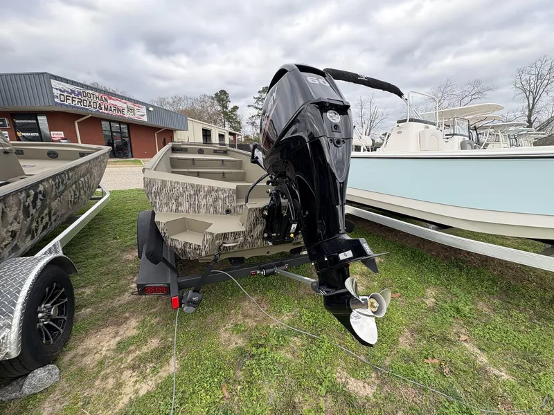 Slide: The Image of 2025 Thor Lake Hammer Hybrid 1754 boat with outboard motor, displayed outdoors. - 3