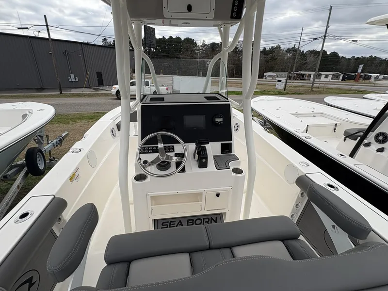 Slide: The Image of 2023 Sea Born LX22 boat interior with steering console and seating. - 10