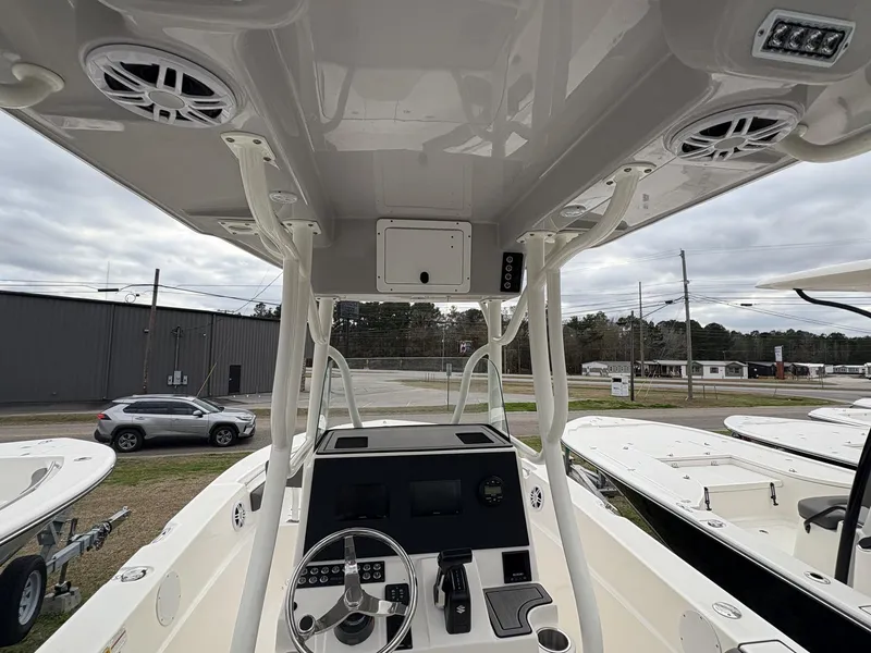 Slide: The Image of 2023 Sea Born LX22 boat interior with steering console and overhead speakers. - 11