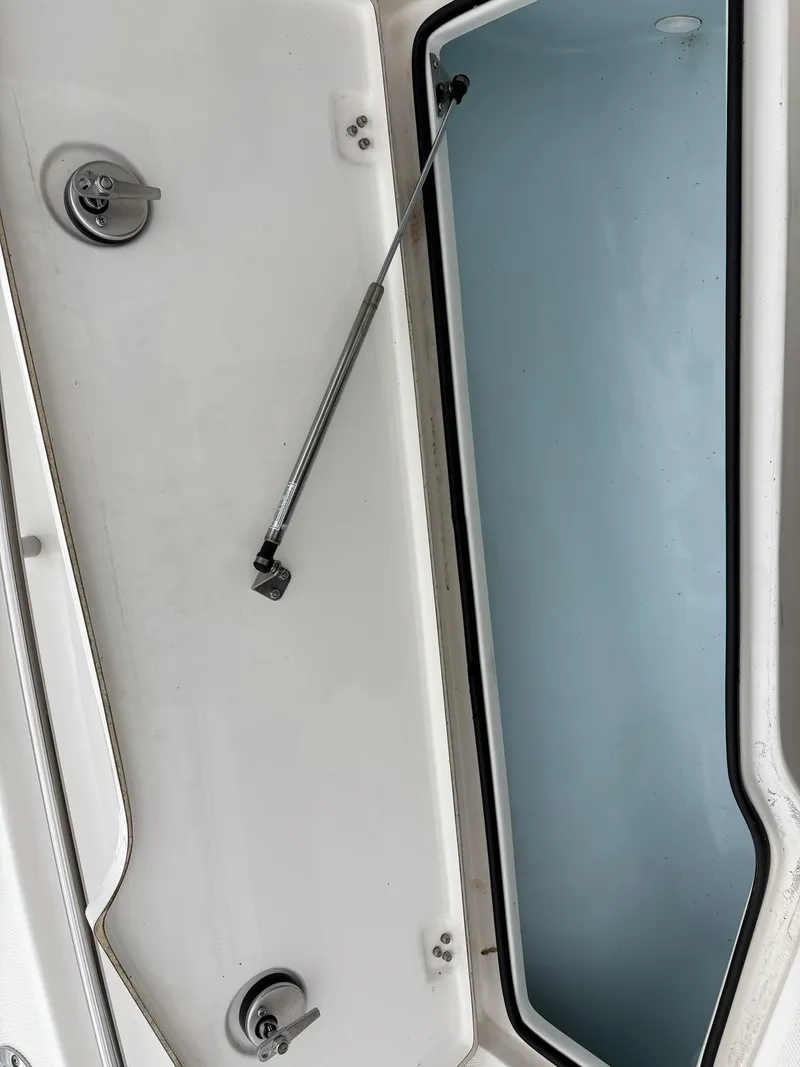 Slide: The Image of Open storage compartment on 2023 Sea Born LX LX22 boat, featuring hydraulic support. - 22