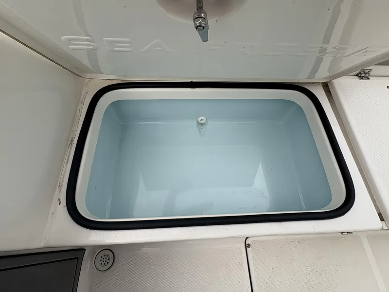Slide: The Image of Livewell compartment on a 2023 Sea Born LX LX22 boat, open and empty. - 6