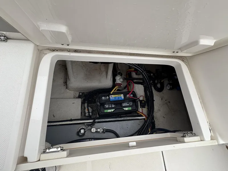 Slide: The Image of 2023 Sea Born LX22 boat battery compartment with wiring and connections. - 7