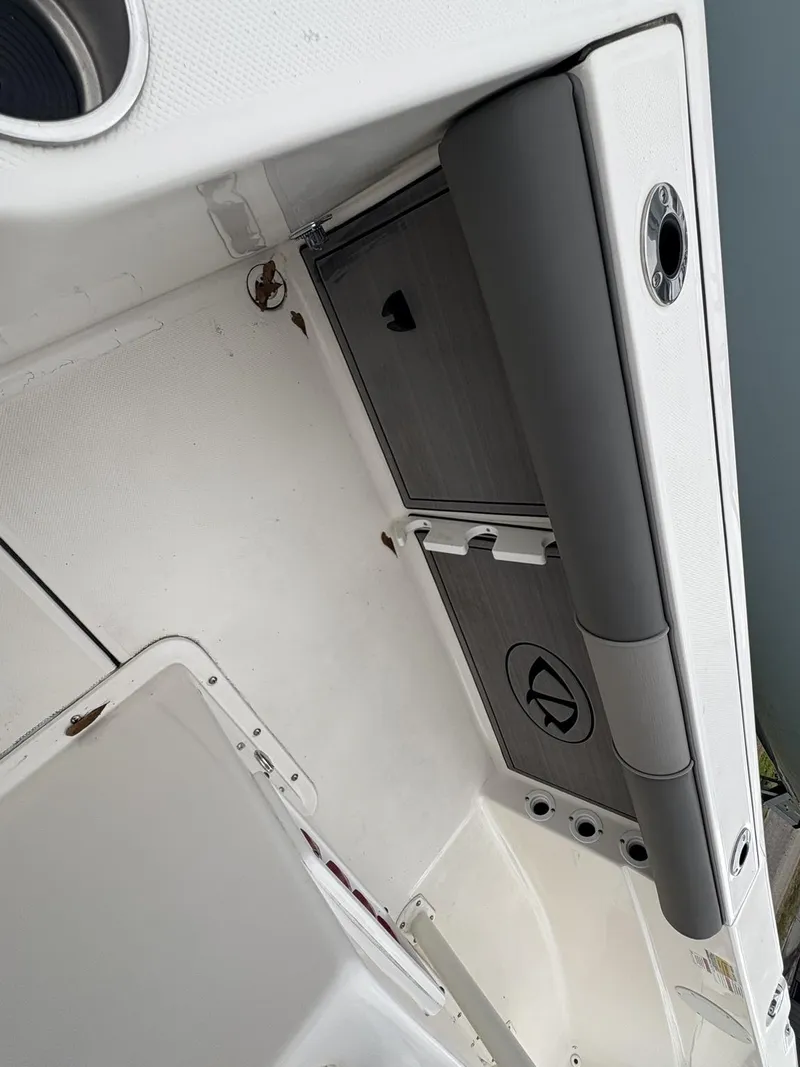 Slide: The Image of 2023 Sea Born LX LX22 boat interior with storage compartments and seating. - 8