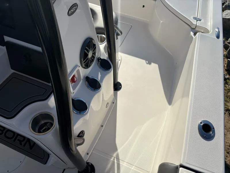 Slide: The Image of 2024 Sea Born FX FX24 boat interior with cup holders and speaker system. - 11