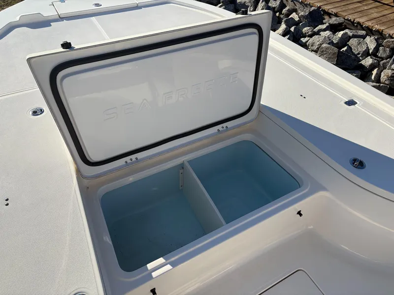 Slide: The Image of 2024 Sea Born FX FX24 boat storage compartment open on deck. - 16