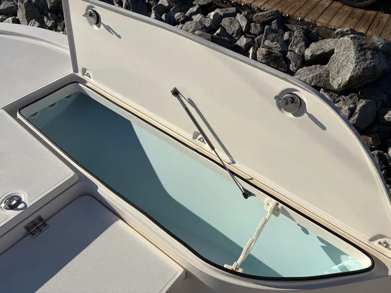 Slide: The Image of 2024 Sea Born FX FX24 boat storage compartment open, revealing spacious interior. - 17