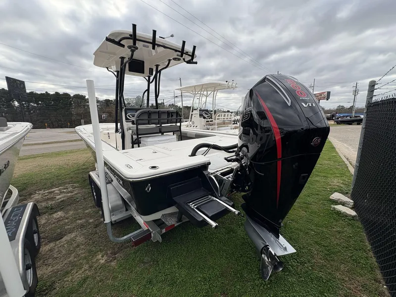 Slide: The Image of 2024 Sea Born FX FX24 boat with powerful outboard motor, parked on grass. - 4