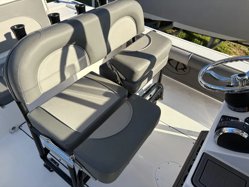 Slide: The Image of 2024 Sea Born FX FX24 boat interior with gray seating and steering wheel. - 8