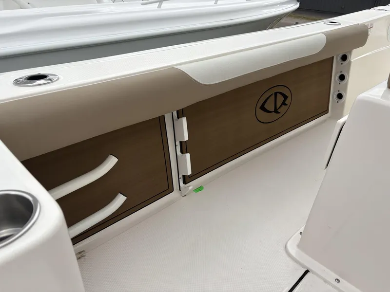 Slide: The Image of 2025 Sea Born LX LX24 boat interior with storage compartments and cup holder. - 10