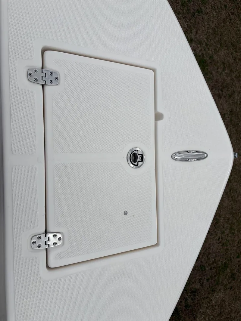 Slide: The Image of 2025 Sea Born LX LX24 boat deck with storage hatch and latch. - 24