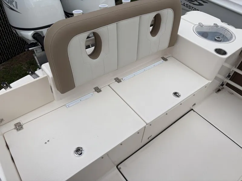 Slide: The Image of 2025 Sea Born LX24 boat seating area with storage compartments and livewell. - 6