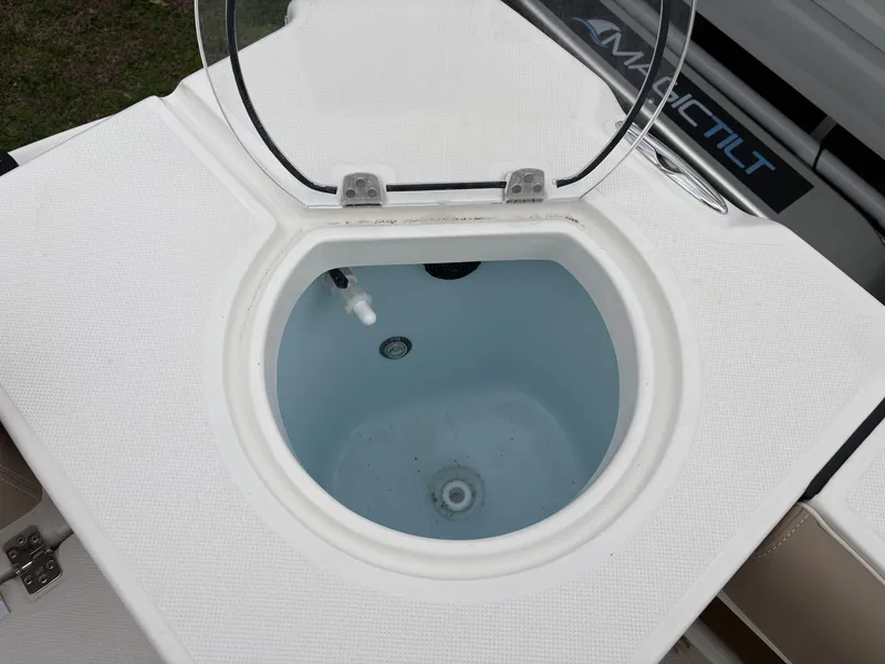 Slide: The Image of Livewell on 2025 Sea Born LX24 boat, open lid, white interior. - 9