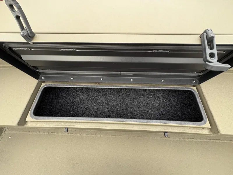 Slide: The Image of Open storage compartment in 2025 Thor Lake Hammer Hybrid 1754 boat. - 7