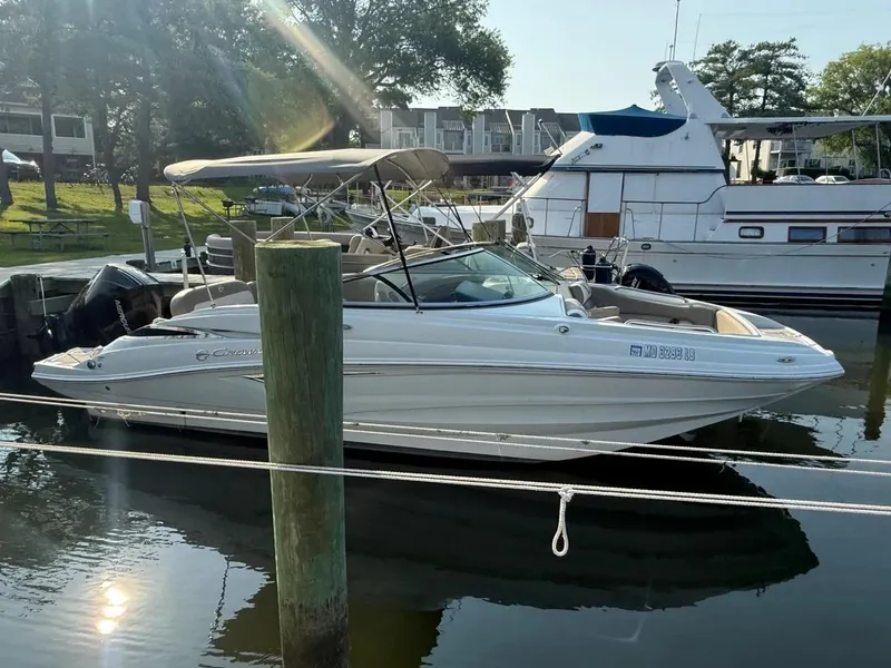 Slide: The Image of 2023 Crownline Eclipse E235 XS boat docked in a marina, sunny day. - 12