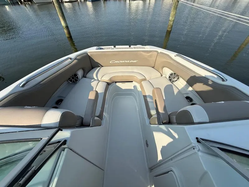 Slide: The Image of 2023 Crownline Eclipse E235 XS boat interior with spacious seating and water view. - 16