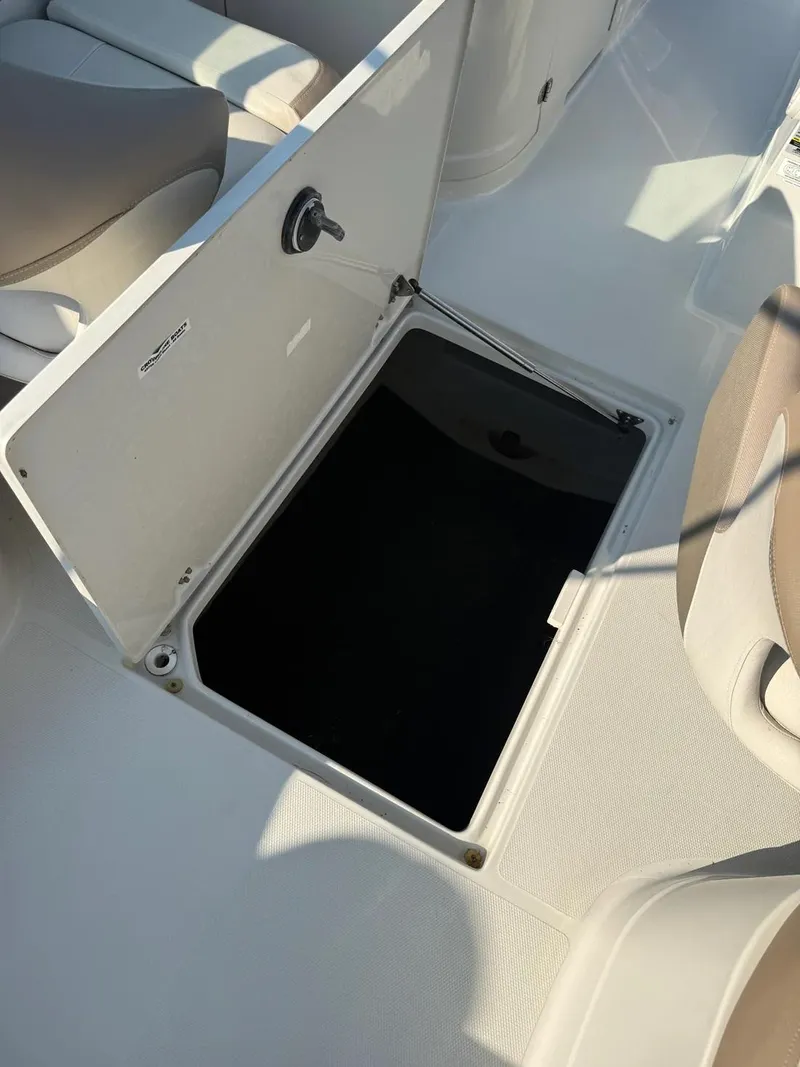 Slide: The Image of Open storage compartment on 2023 Crownline Eclipse E235 XS boat deck. - 18