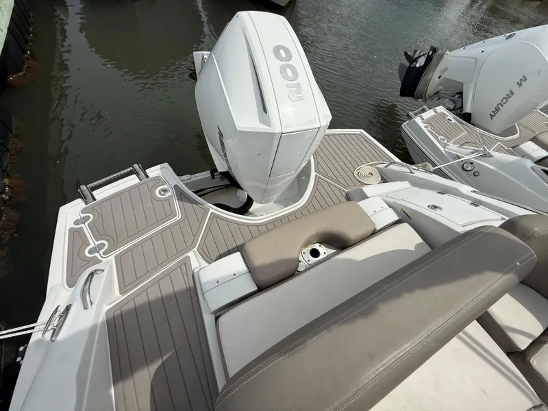 Slide: The Image of 2023 Crownline Eclipse E235 XS boat with outboard motor, featuring sleek deck design. - 9
