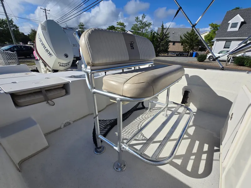 Slide: The Image of 2016 Carolina Skiff 238 DLV boat interior with seating and Evinrude 150 engine. - 10