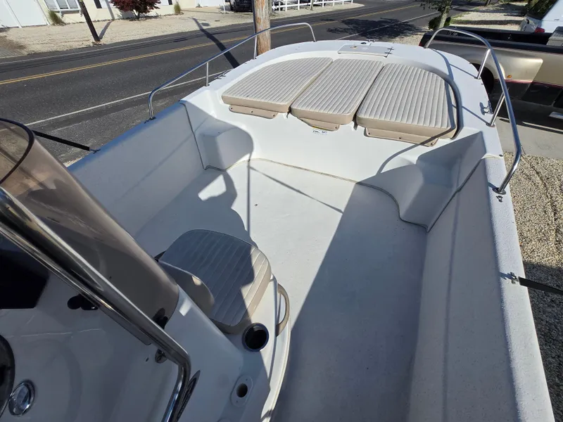 Slide: The Image of 2016 Carolina Skiff 238 DLV boat interior with seating and railings. - 11