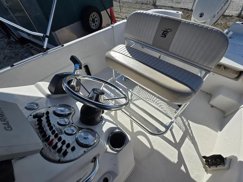 Slide: The Image of 2016 Carolina Skiff 238 DLV boat interior with steering wheel and control panel. - 13
