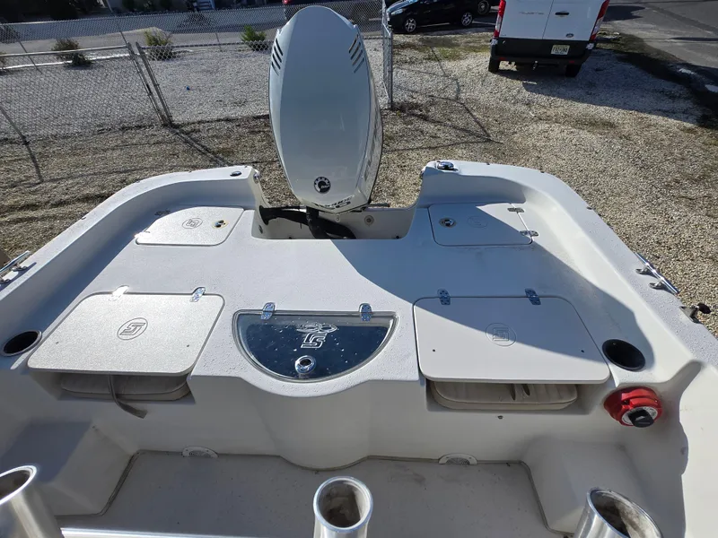 Slide: The Image of 2016 Carolina Skiff 238 DLV boat deck with storage compartments and motor. - 14