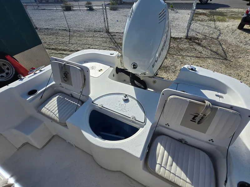 Slide: The Image of 2016 Carolina Skiff 238 DLV boat interior with seating and motor. - 16