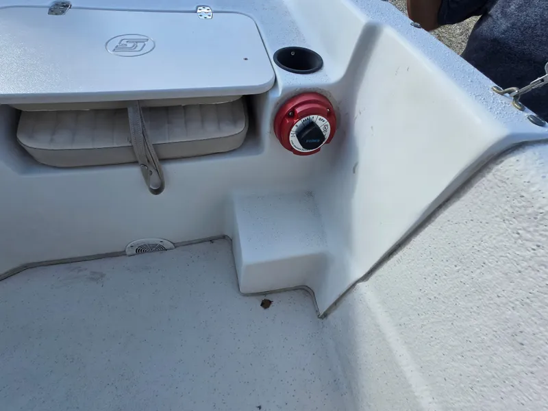 Slide: The Image of 2016 Carolina Skiff 238 DLV boat interior with storage compartment and control panel. - 17