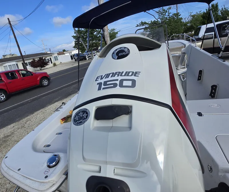 Slide: The Image of 2016 Carolina Skiff 238 DLV with Evinrude 150 engine, parked near a road. - 18