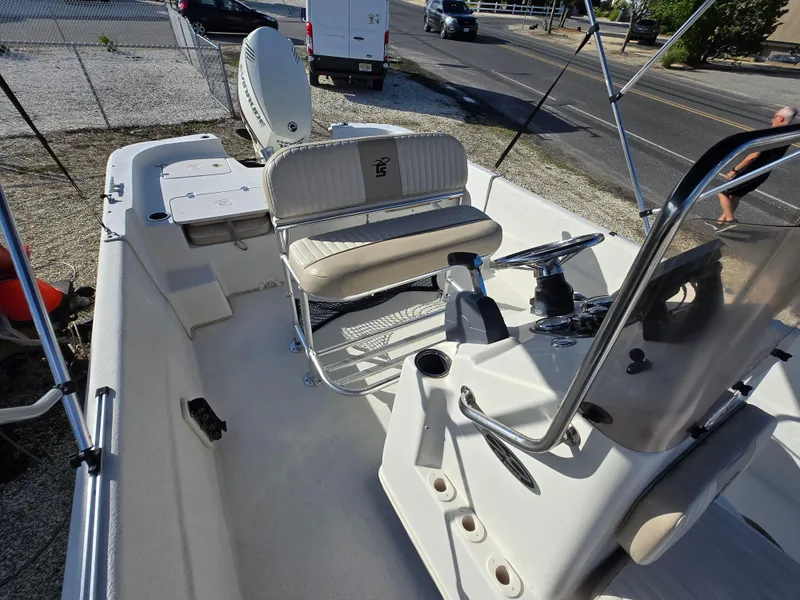 Slide: The Image of 2016 Carolina Skiff 238 DLV boat interior with steering console and seating. - 2