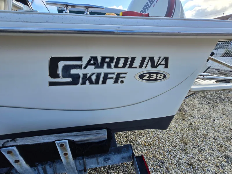 Slide: The Image of 2016 Carolina Skiff 238 DLV boat logo on hull, close-up view. - 20
