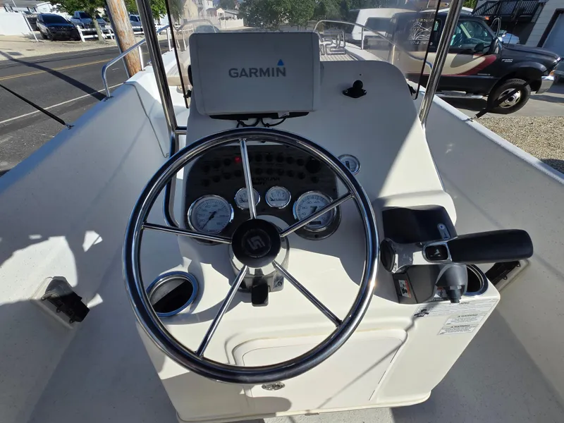 Slide: The Image of 2016 Carolina Skiff 238 DLV boat console with Garmin navigation system and steering wheel. - 21