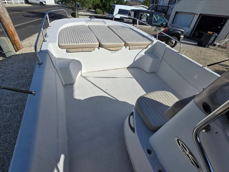 Slide: The Image of 2016 Carolina Skiff 238 DLV boat interior with seating and open deck. - 3