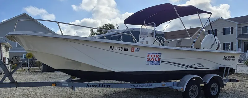 Slide: The Image of 2016 Carolina Skiff 238 DLV boat for sale on trailer, with canopy and outboard motor. - 4