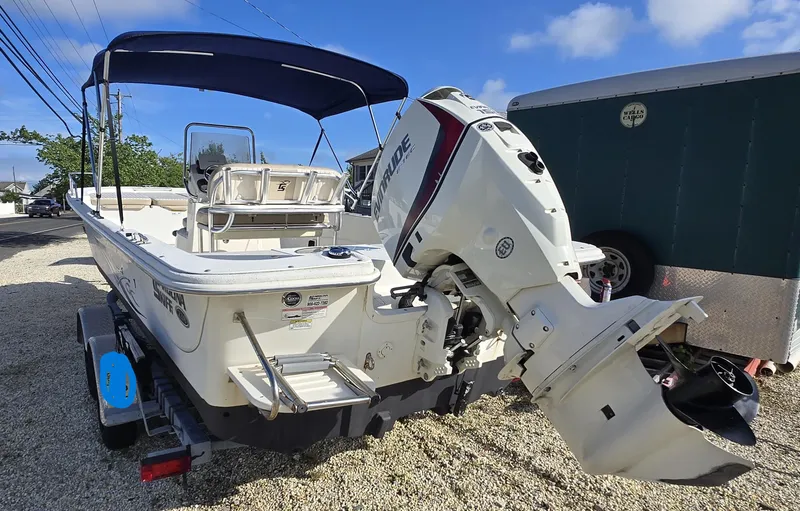 Slide: The Image of 2016 Carolina Skiff 238 DLV boat with outboard motor on trailer. - 6