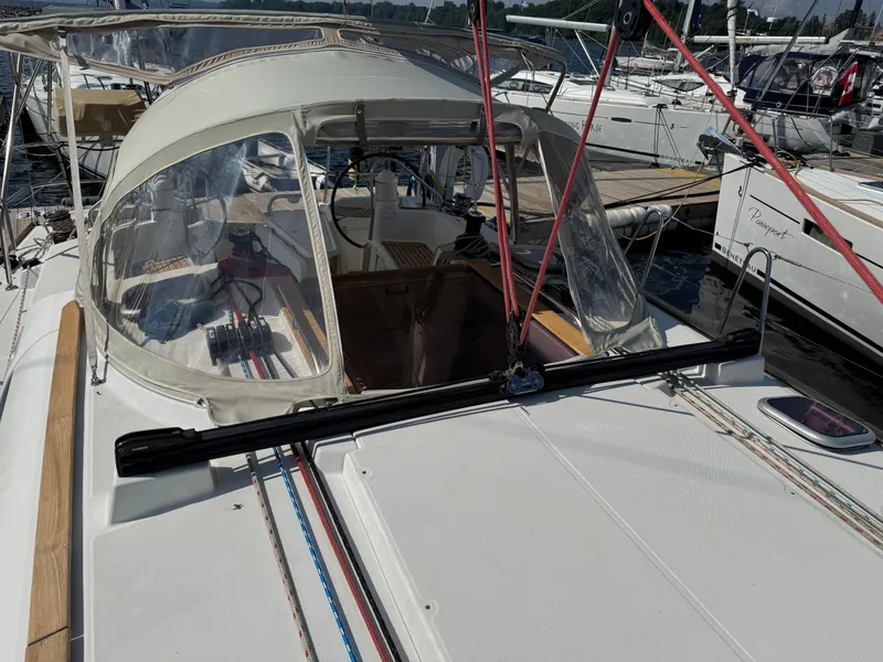 Slide: The Image of 2008 Jeanneau Sun Odyssey 42 I sailboat docked, featuring a covered cockpit and visible rigging. - 12
