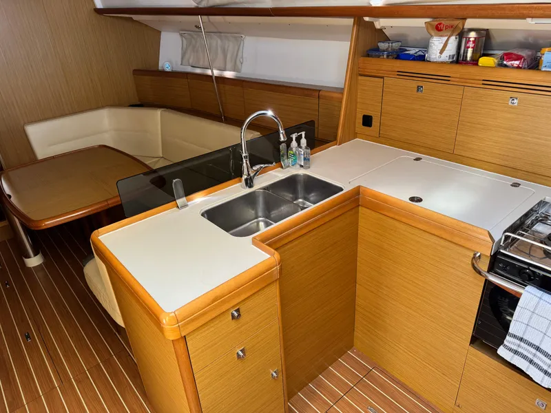 Slide: The Image of Interior of 2008 Jeanneau Sun Odyssey 42 I yacht, featuring a modern kitchen and dining area. - 14