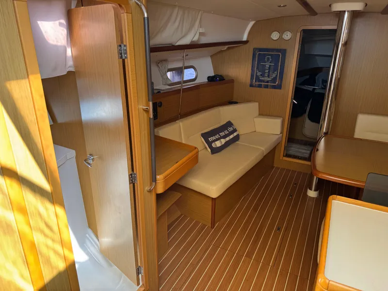 Slide: The Image of Interior of 2008 Jeanneau Sun Odyssey 42 I yacht, featuring wood finish and cozy seating area. - 15