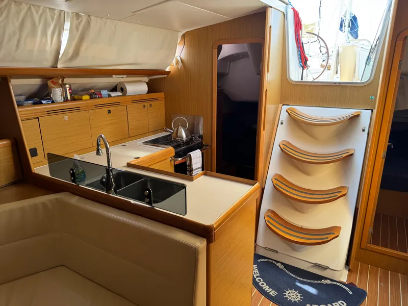Slide: The Image of Interior of 2008 Jeanneau Sun Odyssey 42 I yacht, featuring kitchen and seating area. - 21