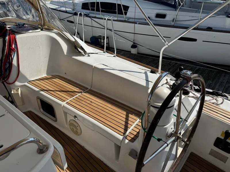 Slide: The Image of Cockpit of 2008 Jeanneau Sun Odyssey 42 I sailboat with wooden seating and steering wheel. - 5