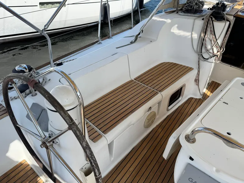 Slide: The Image of Cockpit of 2008 Jeanneau Sun Odyssey 42 I with teak seating and steering wheel. - 6