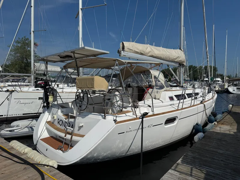 The Image of 2008 Jeanneau Sun Odyssey 42 I sailboat docked at a marina under clear blue skies. - 0