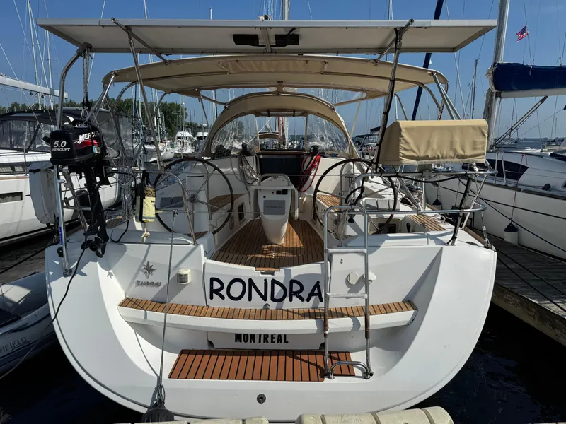 Slide: The Image of 2008 Jeanneau Sun Odyssey 42 I sailboat docked, featuring spacious deck and dual steering wheels. - 1