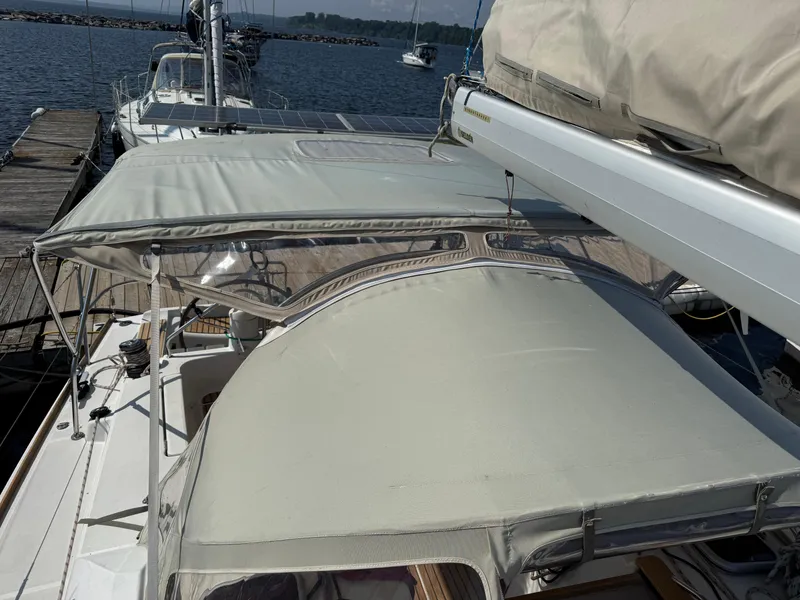 Slide: The Image of 2008 Jeanneau Sun Odyssey 42 I sailboat docked with covered cockpit and boom. - 11