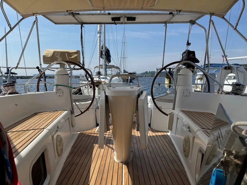 Slide: The Image of 2008 Jeanneau Sun Odyssey 42 I sailboat cockpit with dual steering wheels and teak flooring. - 24