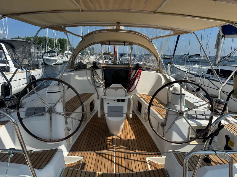 Slide: The Image of 2008 Jeanneau Sun Odyssey 42 I sailboat cockpit with dual steering wheels and teak flooring. - 3