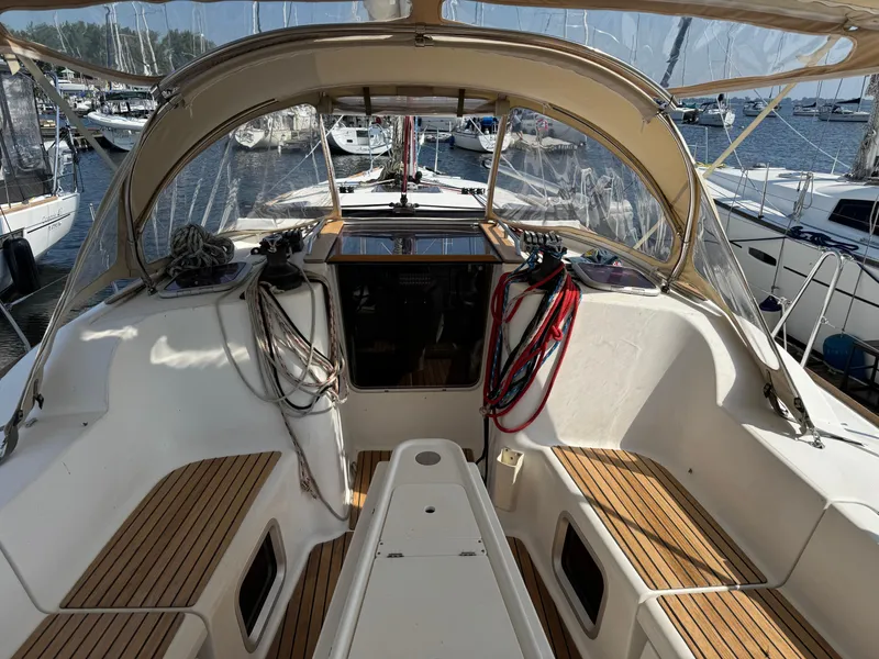 Slide: The Image of 2008 Jeanneau Sun Odyssey 42 I sailboat cockpit with teak seating and marina view. - 4
