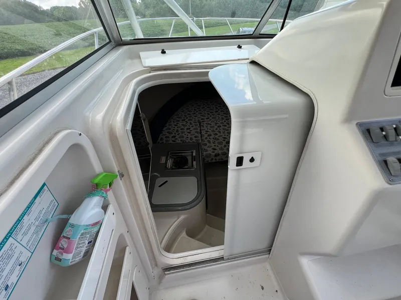 Slide: The Image of 1997 Pro-Line 2810 Walkaround cabin interior with open door and cleaning supplies. - 11