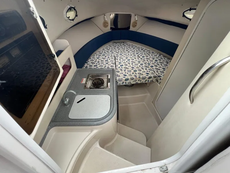 Slide: The Image of 1997 Pro-Line 2810 Walkaround cabin interior with kitchenette and bed. - 12