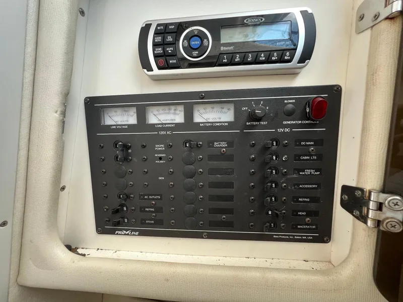 Slide: The Image of Control panel of a 1997 Pro-Line 2810 Walkaround boat with audio system and switches. - 16